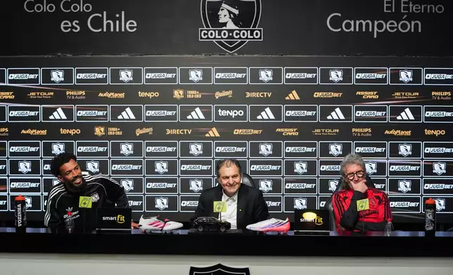 Cape Verde goalkeeper Vozinha, left, Colo Colo's President Anibal Mosa, center, and Colo Colo's sports manager Daniel Moron attend Vozinha's presentation as a new player at Monumental stadium in Santiago, Chile, Tuesday, Aug. 4, 2026. (AP Photo/Esteban Felix)
