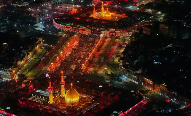Aerial photo shows Shiite pilgrims gathering between the holy shrine of Imam Hussein and the holy shrine of Imam Abbas ahead of Arbaeen, the annual Shiite commemoration marking 40 days after Ashura, in Karbala, Iraq, Sunday, Aug. 2, 2026. (AP Photo/Hadi Mizban)