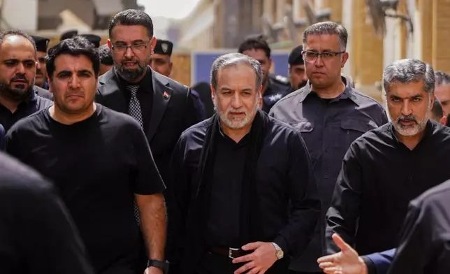 Iranian Foreign Minister Abbas Araghchi, center, is surrounded by security personnel as he walks during the Arbaeen commemoration in Najaf, Iraq, Monday, Aug. 3, 2026. (AP Photo/Anmar Khalil)