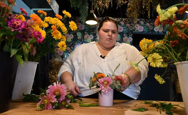 Marisa Mender-Franklin arranges a bouquet on Thursday, July 23, 2026, in her florist shop, Midtown Bramble & Bloom, in Memphis, Tenn. (AP Photo/Kristin M. Hall)