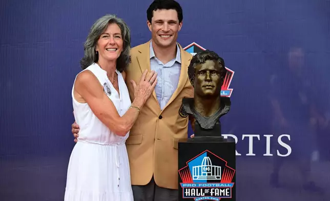 Former NFL player Luke Kuechly, left, poses with his mother, Eileen Kuechly, during the Pro Football Hall of Fame induction ceremony at the Pro Football Hall of Fame, in Canton, Ohio, Saturday, Aug. 8, 2026. (AP Photo/David Dermer)