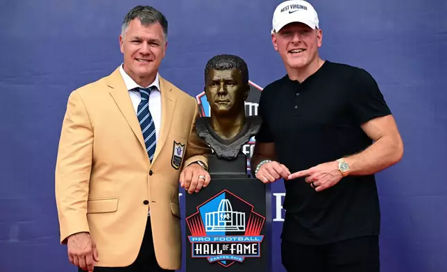 Former NFL player Adam Vinatieri poses with Pat McAfee during the Pro Football Hall of Fame induction ceremony at the Pro Football Hall of Fame, in Canton, Ohio, Saturday, Aug. 8, 2026. (AP Photo/David Dermer)