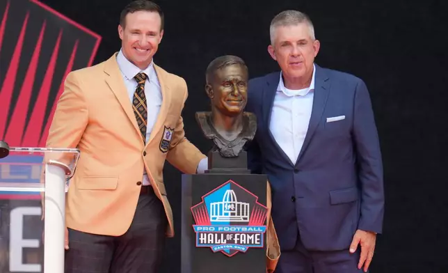 Former NFL player Drew Brees, left, unveils his bust with Sean Payton during the Pro Football Hall of Fame induction ceremony at the Pro Football Hall of Fame, in Canton, Ohio, Saturday, Aug. 8, 2026. (AP Photo/Sue Ogrocki)