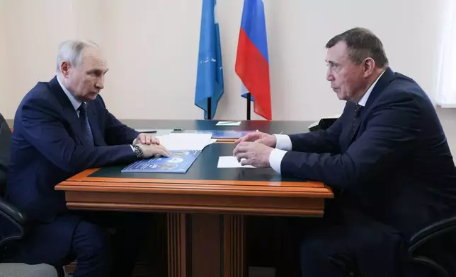 Russian President Vladimir Putin, left, listens to Sakhalin Region Governor Valery Limarenko in Kurilsk on the Iturup Island, the largest of the Kuril Islands of Russia's fareast, on Thursday, Aug. 13, 2026. (Gavriil Grigorov, Sputnik, Kremlin Pool Photo via AP)