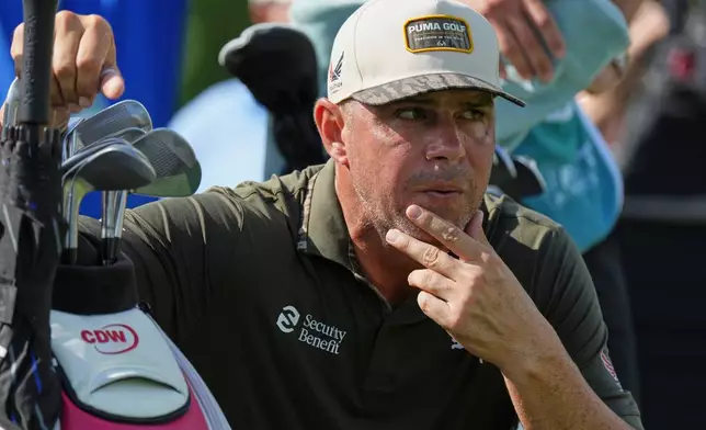 Gary Woodland kneels next to his bag on the second tee during the first round of the BMW Championship golf tournament Thursday, Aug. 20, 2026, in St. Louis. (AP Photo/Jeff Roberson)