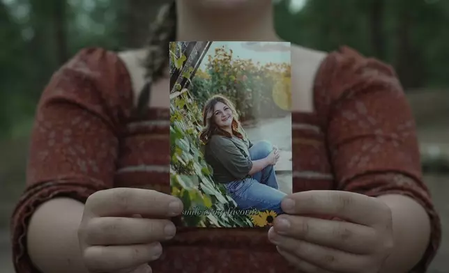 Charlotte Touzalin holds a photo of herself, provided by Bre Blake Photography, showing her before participating in a PMOS study, in Elizabeth, Colo., on Friday, July 10, 2026. (AP Photo/Brittany Peterson, Bre Blake Photography)