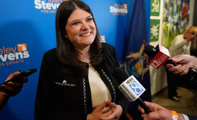 Rep. Haley Stevens, D-Mich., talks to reporters during a campaign event, Monday, Aug. 3, 2026, in Grand Rapids, Mich. (AP Photo/Paul Sancya)
