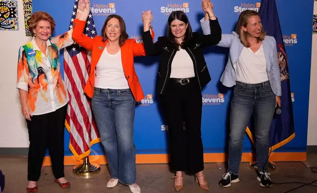 Rep. Haley Stevens, D-Mich., second from right, a candidate in the Democratic primary for U.S. Senate in Michigan, appears with former Sen. Debbie Stabenow, D-Mich., from left, President of EMILY's List Jessica Mackler and Rep. Hillary Scholten, D-Mich., during a campaign event, Monday, Aug. 3, 2026, in Grand Rapids, Mich. (AP Photo/Paul Sancya)