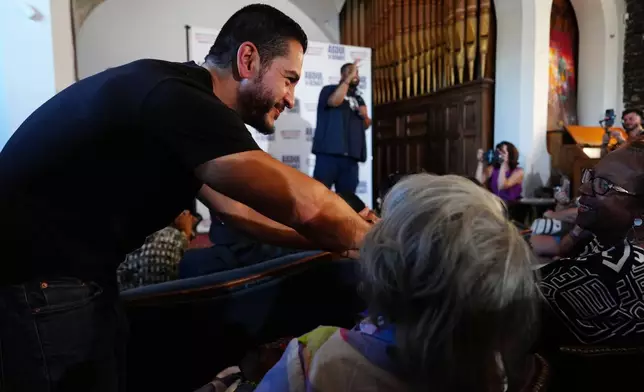 Abdul El-Sayed, a progressive candidate in the Democratic primary for U.S. Senate in Michigan, greets people at a campaign rally, Monday, Aug. 3, 2026, in Detroit. (AP Photo/Julia Demaree Nikhinson)