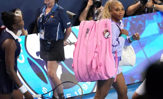 Venus, left, and Serena Williams, right, take the court for their women's doubles match against Marta Kostyuk, of Ukraine, and Peyton Stearns, also of the United States, at the Cincinnati Open tennis tournament, Monday, Aug. 17, 2026, in Mason, Ohio. (AP Photo/Kareem Elgazzar)