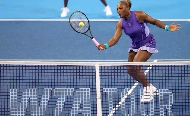 Serena Williams, of the United States, returns a shot against Marta Kostyuk, of Ukraine, and Peyton Stearns, also of the United States, during a women's doubles match at the Cincinnati Open tennis tournament, Monday, Aug. 17, 2026, in Mason, Ohio. (AP Photo/Kareem Elgazzar)