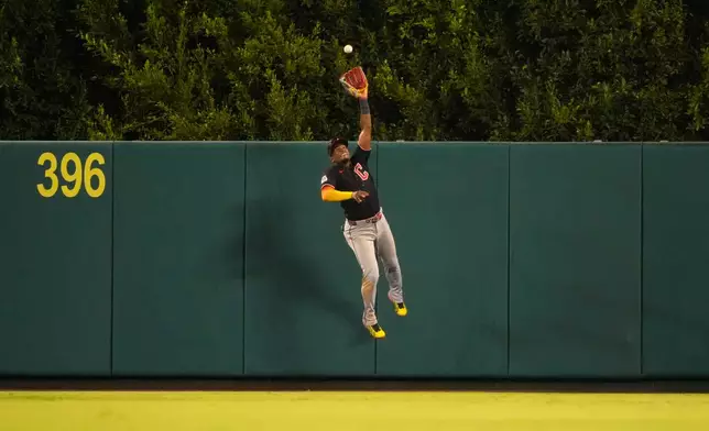 Cleveland Guardians left fielder Angel Martínez makes a catch on a ball hit by Los Angeles Angels' Mike Trout during the eighth inning of a baseball game Tuesday, Aug. 25, 2026, in Anaheim, Calif. (AP Photo/Mark J. Terrill)
