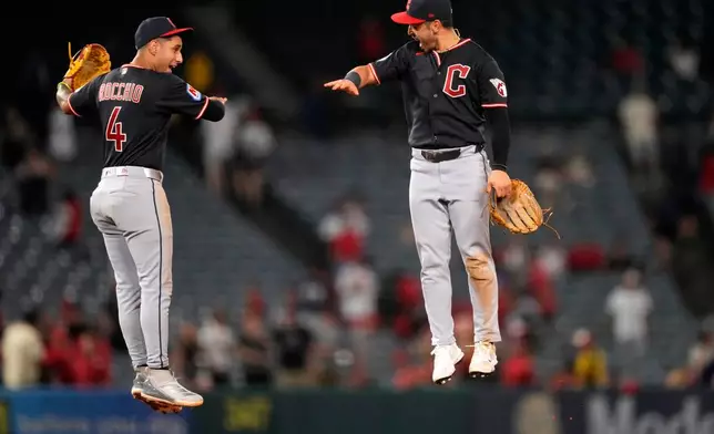 Cleveland Guardians' Brayan Rocchio, left, and left fielder Steven Kwan celebrate after the Guardians defeated the Los Angeles Angels in a baseball game Tuesday, Aug. 25, 2026, in Anaheim, Calif. (AP Photo/Mark J. Terrill)