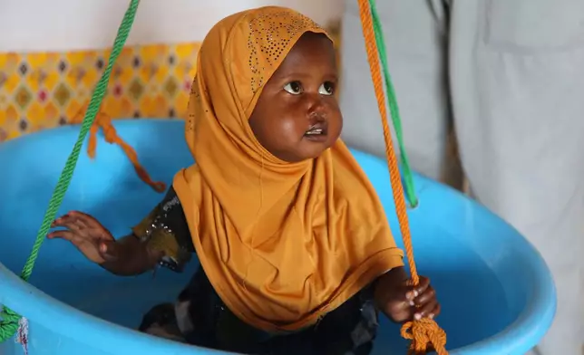 A child is weighed at Feynuus Nutrition Centre on the outskirts of the capital, Mogadishu, Somalia Wednesday, Aug. 19, 2026. (AP Photo/Farah Abdi Warsameh)