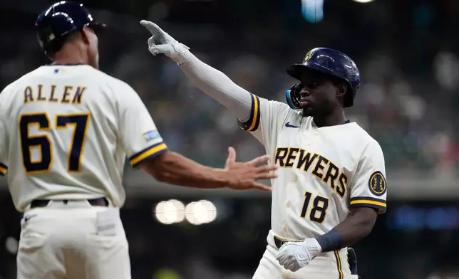 Milwaukee Brewers' Luis Lara (18) gestures after hitting an RBI single during the fifth inning of a baseball game against the Pittsburgh Pirates, Tuesday, Aug. 4, 2026, in Milwaukee. (AP Photo/Aaron Gash)