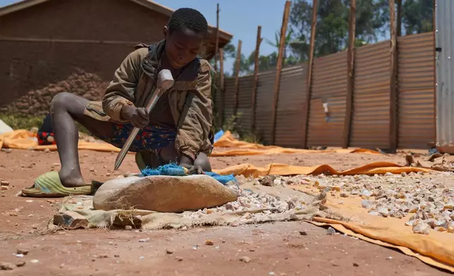 Isaac Batisa 11 years old, searches for gold at a mining site in Iga-Barrière, Ituri province, eastern Congo, Friday, Aug. 14, 2026. (AP Photo/Dieudonne Dirole)