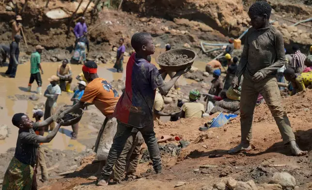Adults and children search for gold at a mining site in Iga-Barrière, Ituri province, eastern Congo, Friday, Aug. 14, 2026. (AP Photo/Dieudonne Dirole)