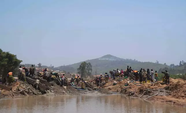 People search for gold at a mining site in Iga-Barrière, Ituri province, eastern Congo, Friday, Aug. 14, 2026. (AP Photo/Dieudonne Dirole)
