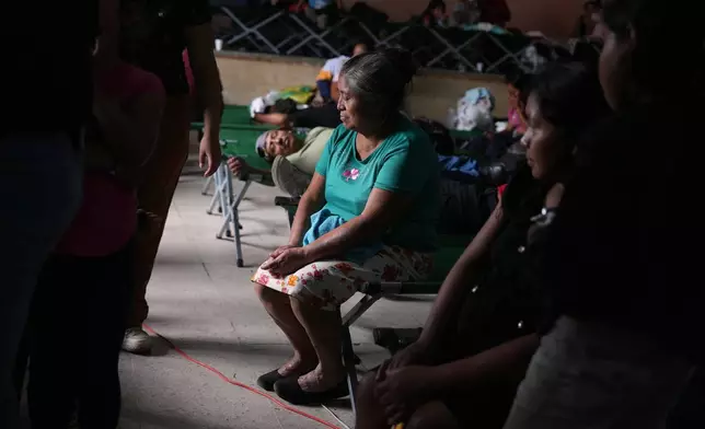 Residents evacuated from areas surrounding the Fuego volcano rest in a temporary shelter in San Juan Alotenango, Guatemala, Tuesday, Aug. 4, 2026. (AP Photo/Moises Castillo)