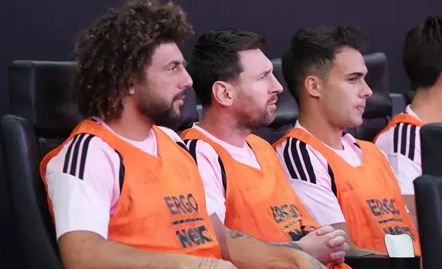 Inter Miami forward Leo Messi, center, sits on the bench before a Leagues Cup soccer match against Club León, Wednesday, Aug. 12, 2026, in Miami. (AP Photo/Lynne Sladky)