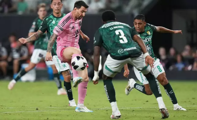 Inter Miami forward Leo Messi, left controls the ball as Club León forward Juan Domínguez (8) defends during the second half of a Leagues Cup soccer match, Wednesday, Aug. 12, 2026, in Miami. (AP Photo/Lynne Sladky)