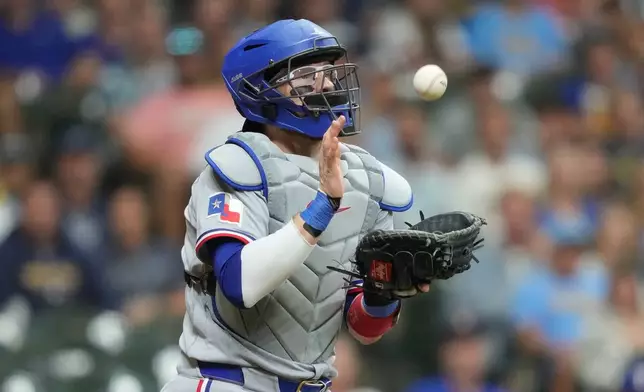 Texas Rangers catcher Danny Jansen catches a bunt hit by Milwaukee Brewers' Joey Ortiz during the sixth inning of a baseball game Friday, Aug. 28, 2026, in Milwaukee. (AP Photo/Kayla Wolf)