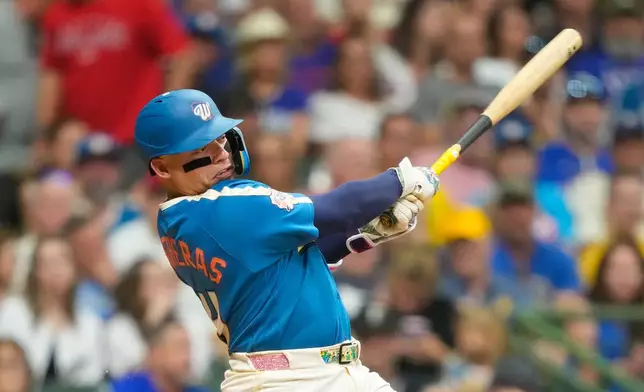 Milwaukee Brewers' William Contreras hits an RBI single, allowing Jake Bauers to score, during the seventh inning of a baseball game against the Texas Rangers, Friday, Aug. 28, 2026, in Milwaukee. (AP Photo/Kayla Wolf)