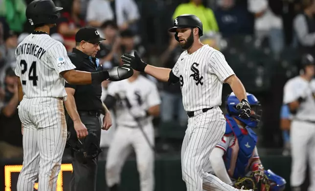 Chicago White Sox's Tristan Peters, right, celebrates with teammate Braden Montgomery (24) after hitting a two-run home run during the second inning of a baseball game against the Texas Rangers in Chicago, Monday, Aug. 24, 2026. (AP Photo/Paul Beaty)