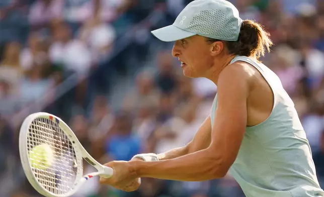 Iga Swiatek, of Poland, returns the ball from Elena Rybakina, of Kazakhstan during a National Bank Open final tennis match, in Toronto, Thursday, Aug. 13, 2026. (Chris Young/The Canadian Press via AP)