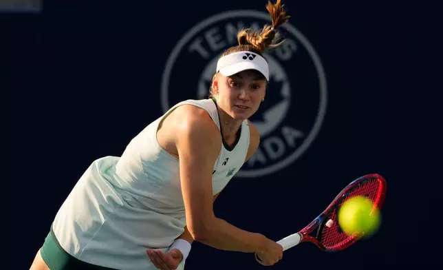 Kazakhstan's Elena Rybakina serves to Poland's Iga Swiatek during a National Bank Open final tennis match, in Toronto, Thursday, Aug. 13, 2026. (Chris Young/The Canadian Press via AP)