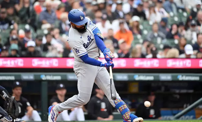 Los Angeles Dodgers' Teoscar Hernández hits a single during the fourth inning of a baseball game against the Detroit Tigers, Sunday, Aug. 30, 2026, in Detroit. (AP Photo/Jose Juarez)