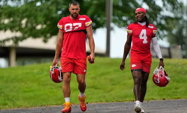 Kansas City Chiefs tight end Travis Kelce (87), and wide receiver Rashee Rice (4) walk to NFL football training camp Friday, July 31, 2026, in St. Joseph, Mo. (AP Photo/Charlie Riedel)