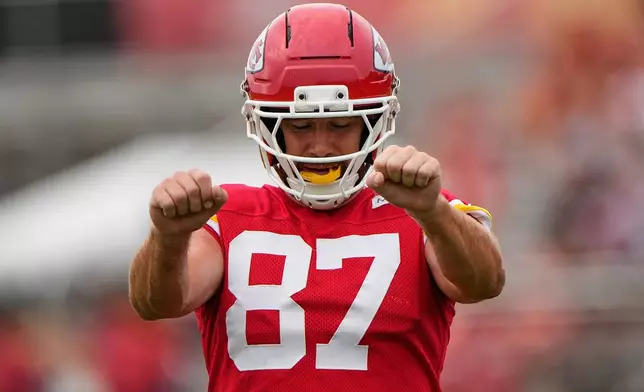 Kansas City Chiefs tight end Travis Kelce stretches during NFL football training camp Friday, July 31, 2026, in St. Joseph, Mo. (AP Photo/Charlie Riedel)