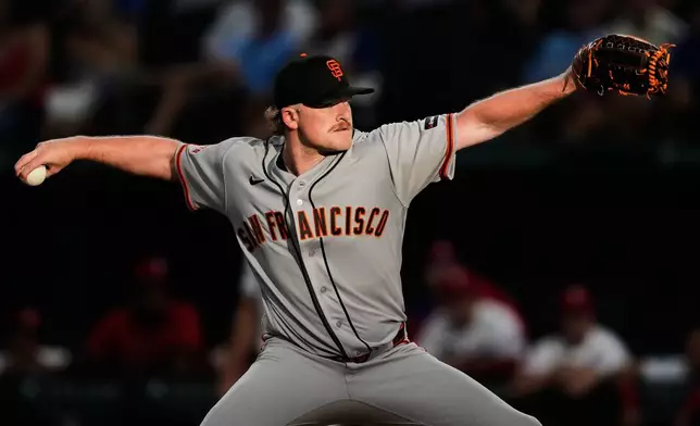 San Francisco Giants pitcher Logan Webb throws to the Texas Rangers in the first inning of a baseball game in Arlington, Texas, Monday, Aug. 3, 2026. (AP Photo/Tony Gutierrez)