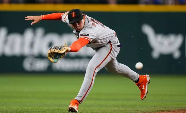San Francisco Giants shortstop Willy Adames is unable to reach a single by Texas Rangers' Ezequiel Duran in the fourth inning of a baseball game in Arlington, Texas, Monday, Aug. 3, 2026. (AP Photo/Tony Gutierrez)
