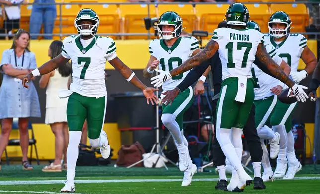 New York Jets quarterback Geno Smith (7) greets teammates before an NFL preseason football game against the Pittsburgh Steelers, Friday, Aug. 21, 2026, in Pittsburgh. (AP Photo/Justin Berl)