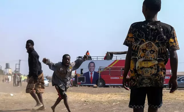 Supporters of Zambian incumbent President and United Party for National Development (UPND) presidential candidate Hakainde Hichilema attend a campaign rally on the outskirts of Lusaka, Zambia, Saturday, Aug. 8, 2026. (AP Photo/Anita Reed)