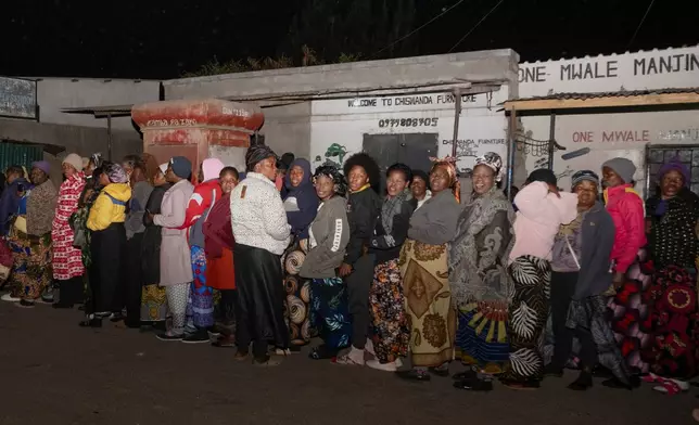 Zambians queue outside a polling station on the outskirts of Lusaka, Zambia, Thursday, Aug. 13, 2026. (AP Photo/Anita Reed)