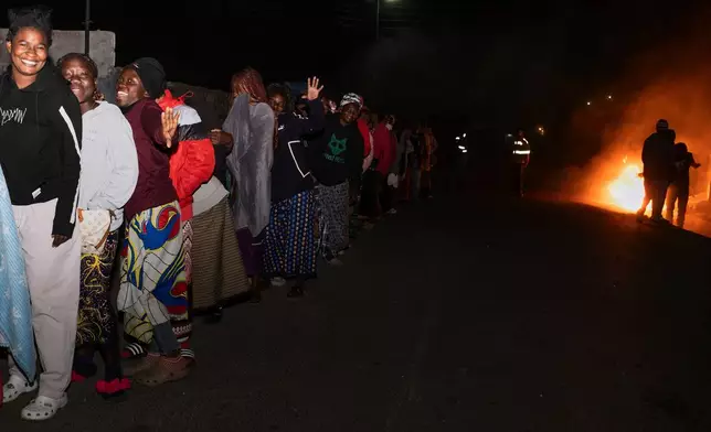 Zambians queue outside a polling station on the outskirts of Lusaka, Zambia, Thursday, Aug. 13, 2026. (AP Photo/Anita Reed)