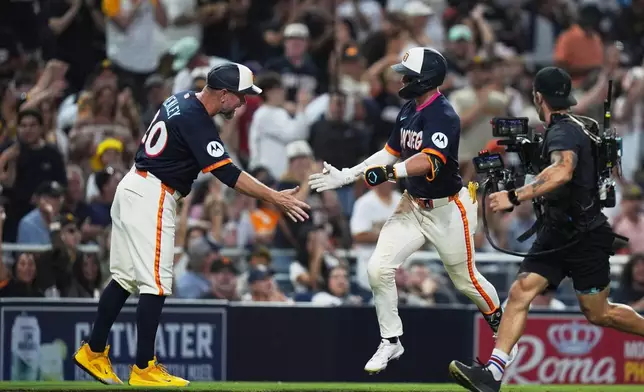 San Diego Padres' Jase Bowen, right, celebrates with third base coach Bob Henley after hitting a home run during the fourth inning of a baseball game against the San Francisco Giants Friday, July 31, 2026, in San Diego. (AP Photo/Gregory Bull)