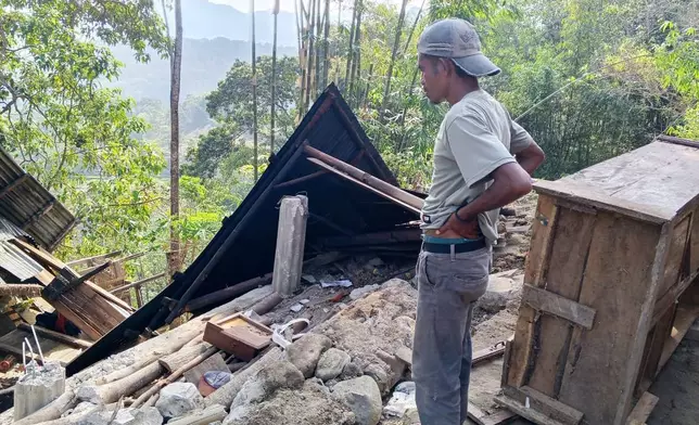 A man examines the damage to a building following an earthquake in East Manggarai, East Nusa Tenggara province, Indonesia, Saturday, Aug. 15, 2026. (AP Photo/Kurniawan)