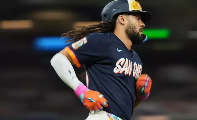 San Diego Padres' Fernando Tatis Jr. watches his single during the seventh inning of a baseball game against the Houston Astros Friday, Aug. 7, 2026, in San Diego. (AP Photo/Gregory Bull)