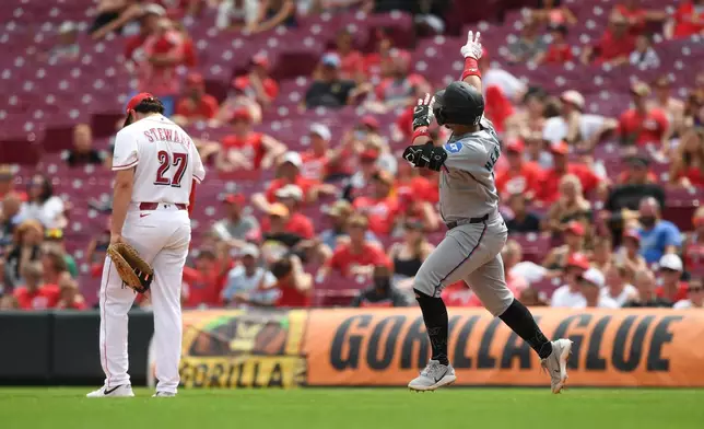Miami Marlins' Heriberto Hernández, right, rounds the bases after hitting a solo home run during the eighth inning of a baseball game against the Cincinnati Reds, Sunday, Aug. 16, 2026, in Cincinnati. (AP Photo/Tanner Pearson)