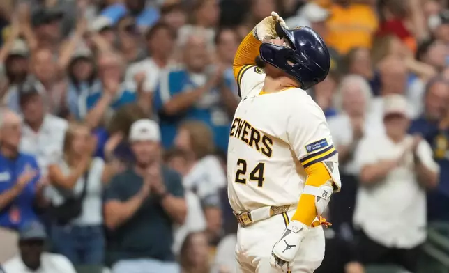 Milwaukee Brewers' William Contreras gestures as he crosses home plate after hitting a solo home run during the sixth inning of a baseball game against the Pittsburgh Pirates, Wednesday, Aug. 5, 2026, in Milwaukee. (AP Photo/Aaron Gash)