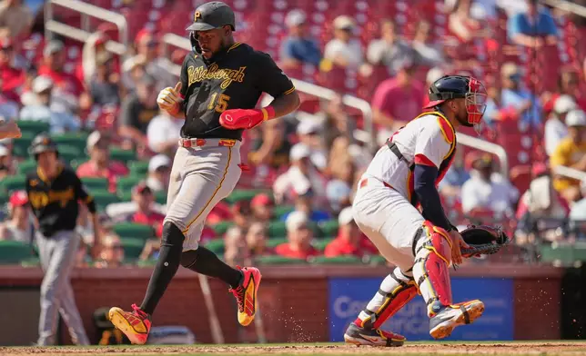 Pittsburgh Pirates' Oneil Cruz (15) scores past St. Louis Cardinals catcher Iván Herrera during the seventh inning of a baseball game Sunday, Aug. 30, 2026, in St. Louis. (AP Photo/Jeff Roberson)