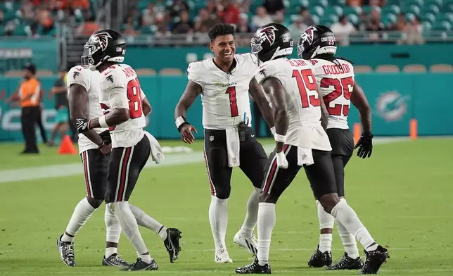 Atlanta Falcons quarterback Tua Tagovailoa (1) celebrates with teammates during the first half of an NFL preseason football game against the Miami Dolphins, Friday, Aug. 28, 2026, in Miami Gardens, Fla. (AP Photo/Lynne Sladky)