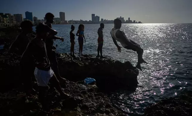 A bather jumps into the sea in Havana, Wednesday, Aug. 19, 2026. (AP Photo/Ramon Espinosa)