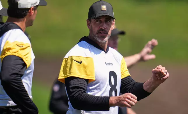 Pittsburgh Steelers quarterbacks Aaron Rodgers (8) and Mason Rudolph, left, discuss a play during the team's NFL football training camp in Latrobe, Pa., on Friday, July 31, 2026.(AP Photo/Gene J. Puskar)
