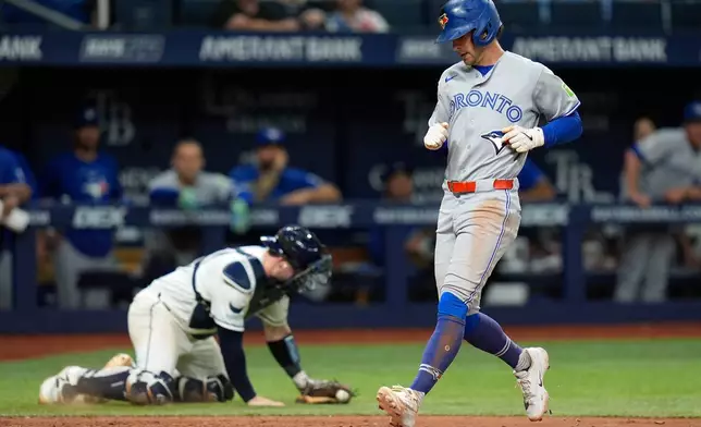 Toronto Blue Jays' Ernie Clement scores on an RBI single by Brett Bateman off Tampa Bay Rays pitcher Steven Matz during the fifth inning of a baseball game Tuesday, Aug. 18, 2026, in St. Petersburg, Fla. (AP Photo/Chris O'Meara)
