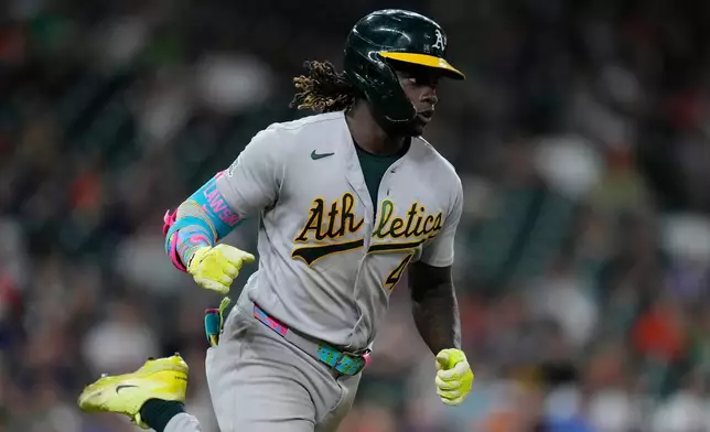 Athletics' Lawrence Butler runs to first base after hitting an RBI single during the eighth inning of a baseball game against the Houston Astros, Saturday, Aug. 22, 2026, in Houston. (AP Photo/Kevin M. Cox)